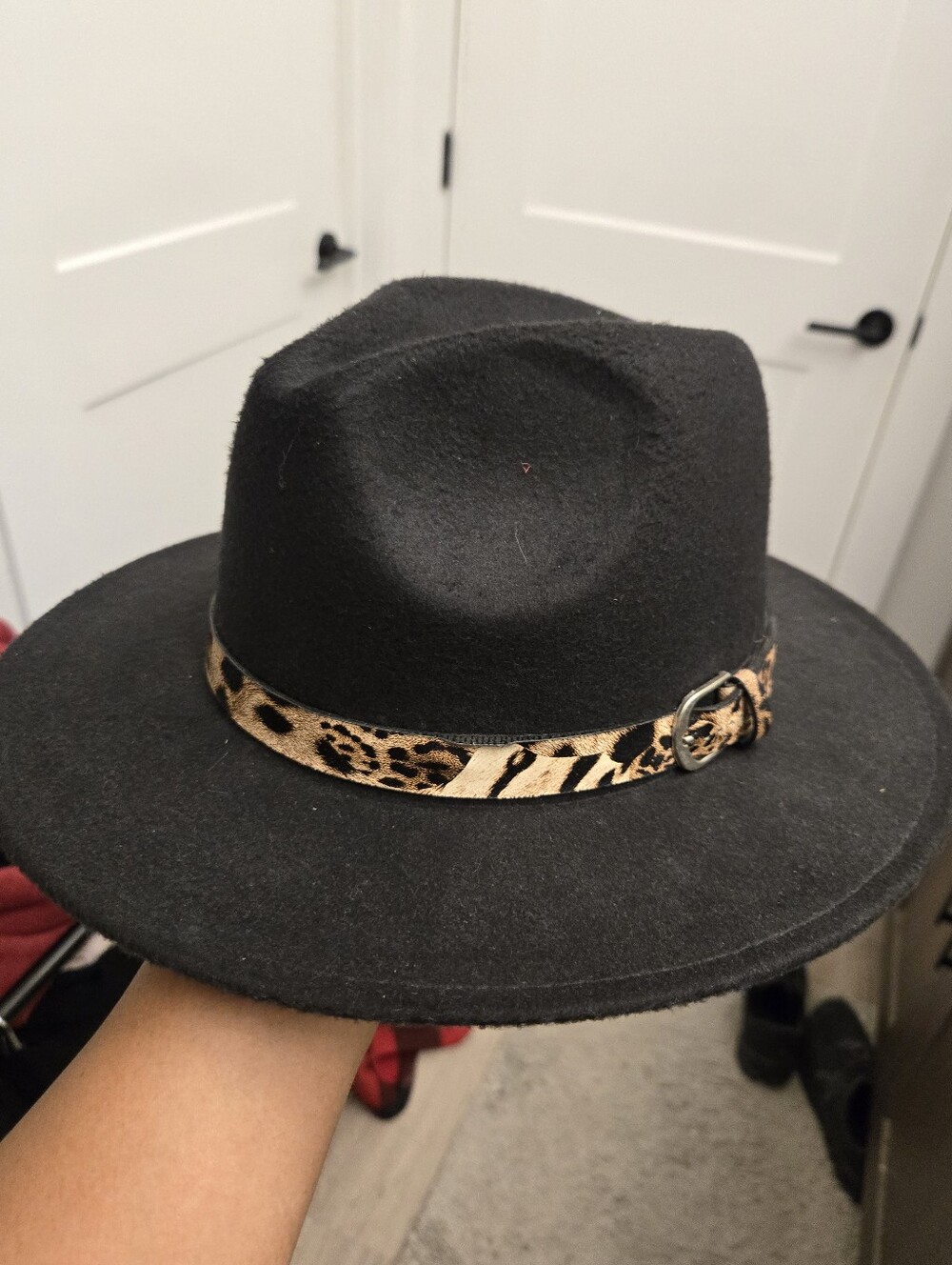 black wide-brim felt fedora hat featuring a decorative leopard-print belt band